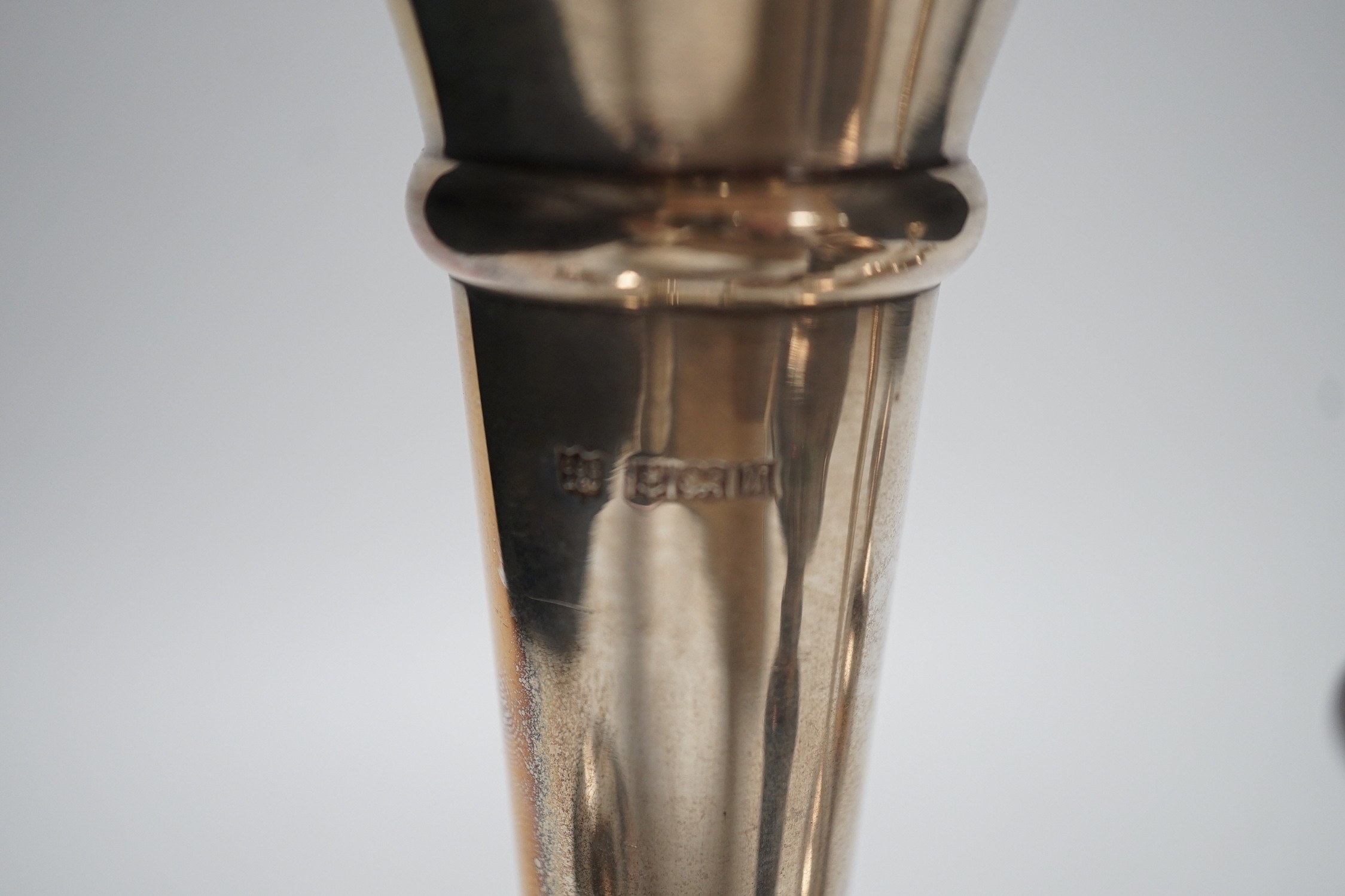 A pair of modern silver mounted candlesticks, 15.4cm, weighted, three other silver mounted dwarf candlesticks and a silver mounted spill vase.